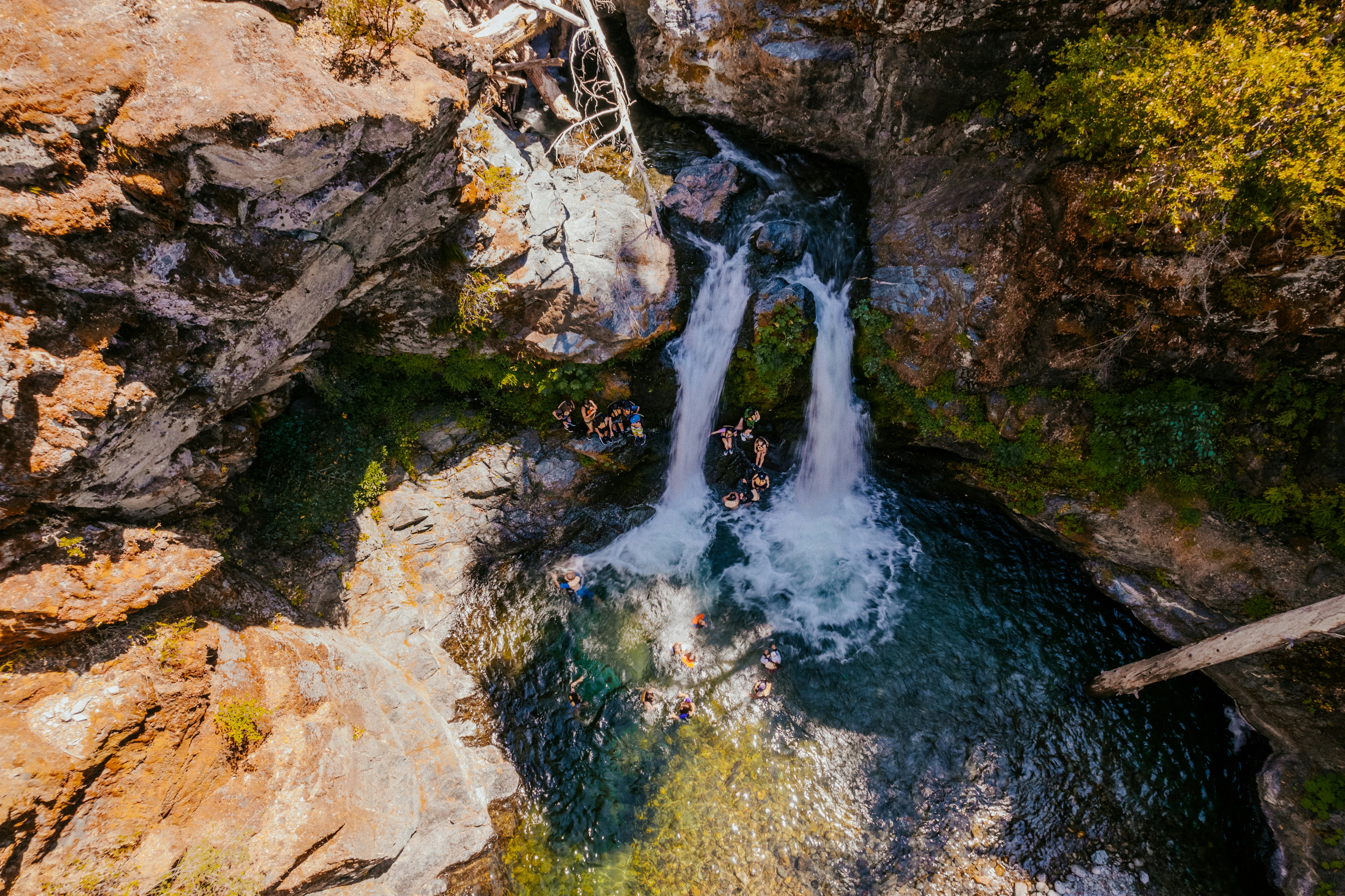 water falls on brown rocky mountain